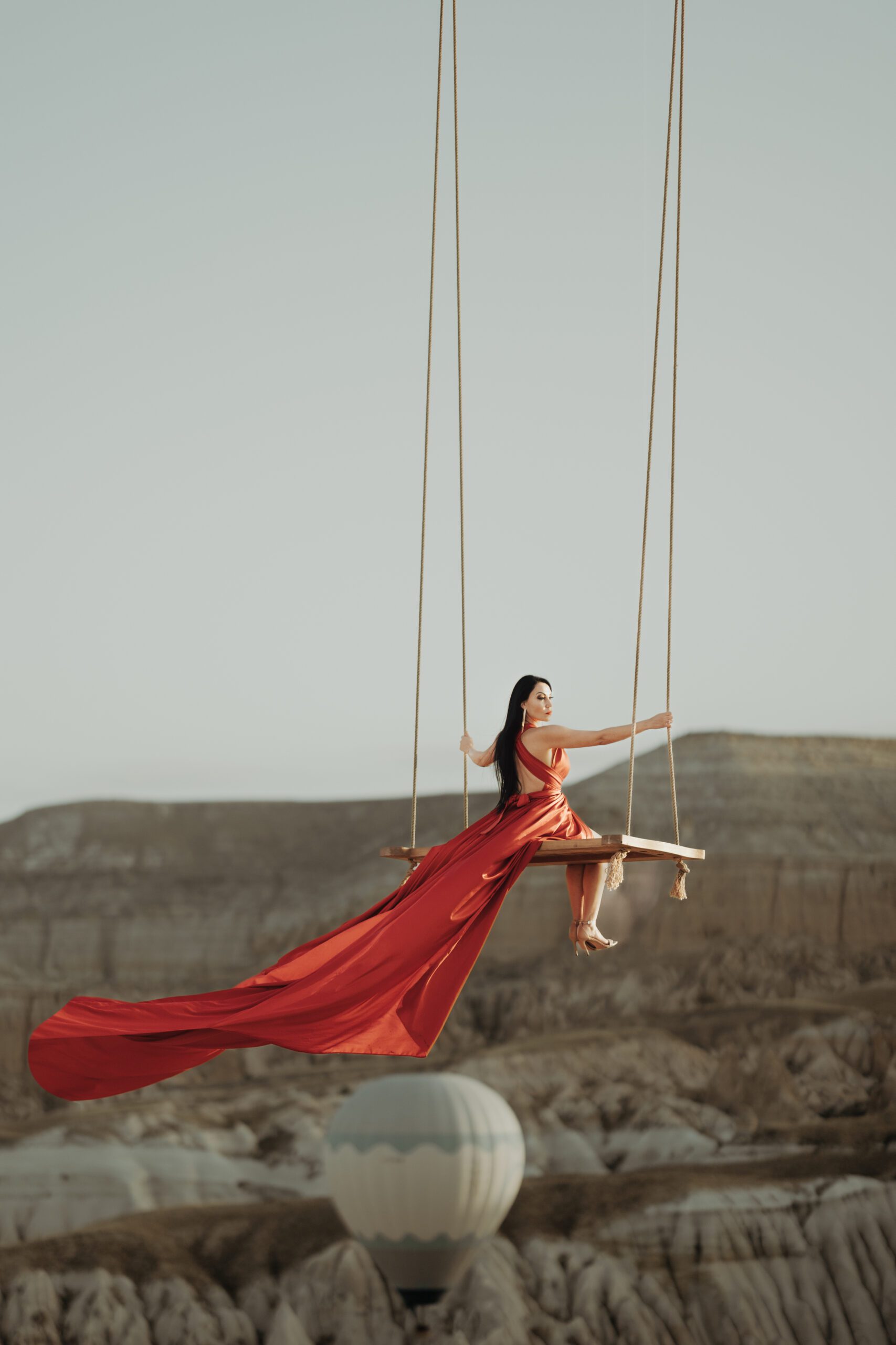 Red-dress swing photoshoot in Cappadocia